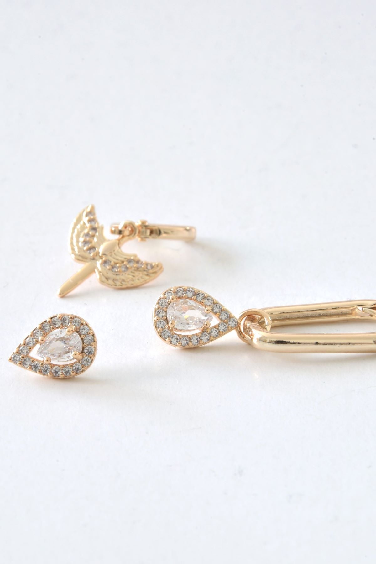 Infinity-ørering i gull, dekorert med zirkonsteiner, med et elegant og tidløst design.